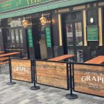 Wooden Framed Cafe Panels outside The Grapes in Liverpool, Restaurant Cafe Panels, Metal Powder Coated Cafe Panels, Wooden Cafe Panels with Branding, Bespoke Cafe Panels, Custom-Made Cafe Panels, Commercial Cafe Panels, Hospitality Cafe Panels, printed cafe barriers