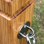 Close Up of a Wall Plate in Stainless Steel on a Rustic Rope Barrier