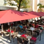 Big Ben Caravita Commercial Giant Umbrella in Red outside Restaurant