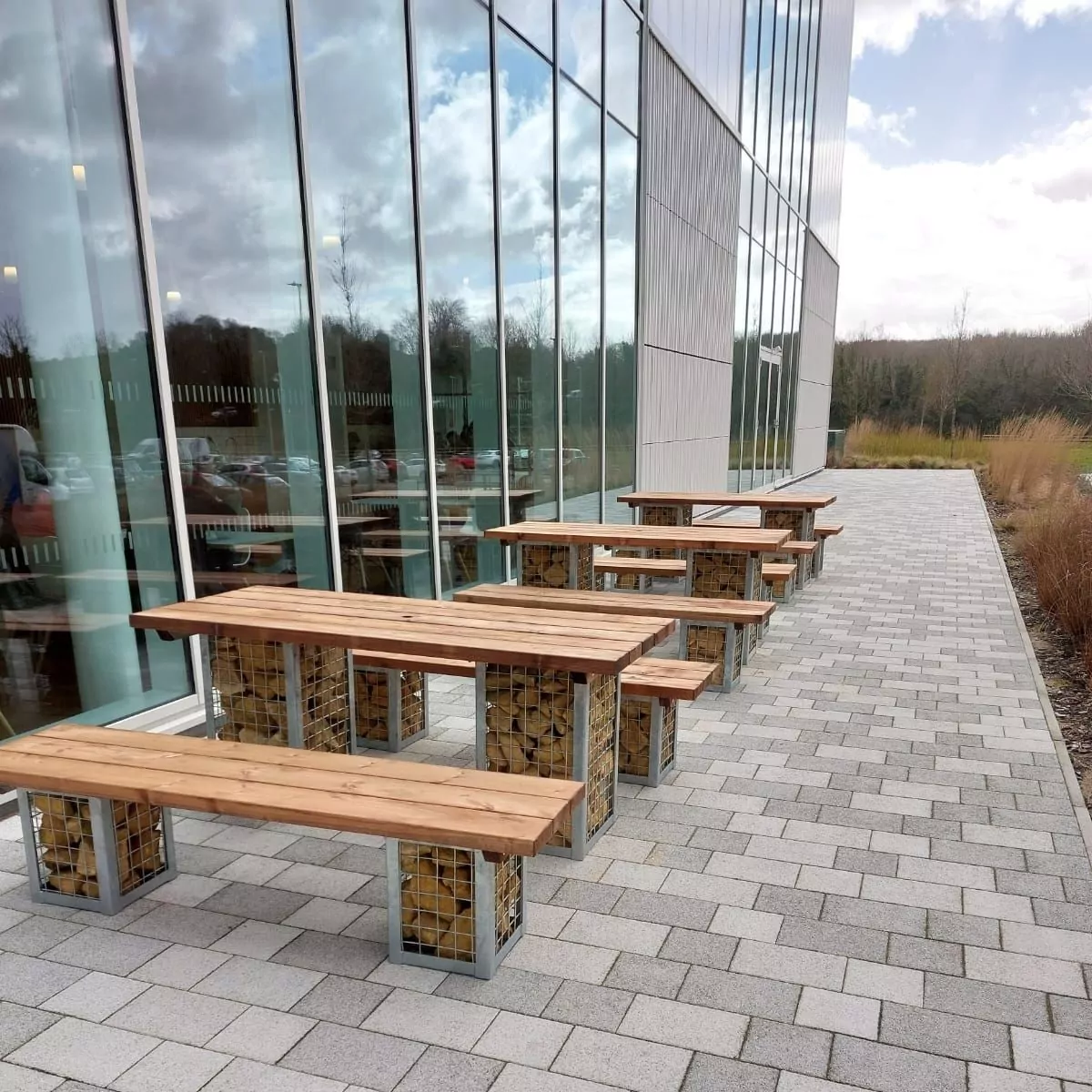 Commercial Outdoor Furniture Outside Winchester Sports & Leisure Centre - Rectangular Gabion Wooden & Metal Tables with Gabion Wooden & Metal Benches for Use Outdoors