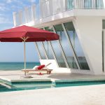 Commercial Parasols, Commercial Giant Umbrella - Primus in Red with Valance by the side of pool, Caravita Umbrellas, Hospitality Parasols, Pub Parasols, Giant Umbrellas